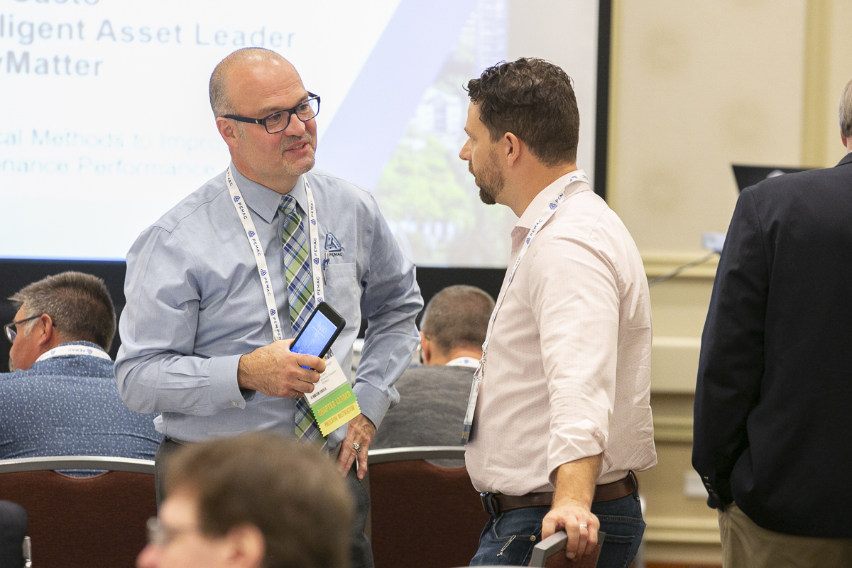 Alberta Chapter President Dennis Heinzlmeir talking with a conference participant