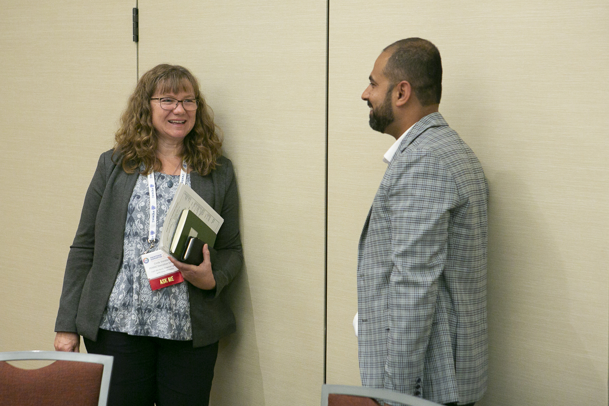 Executive Director Cindy Snedden chatting with Hammad Sharif