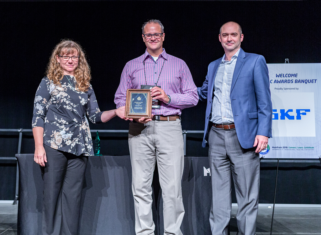 Receiving the award on behalf of the team, Greg Wright and J.-P. Pascoli.