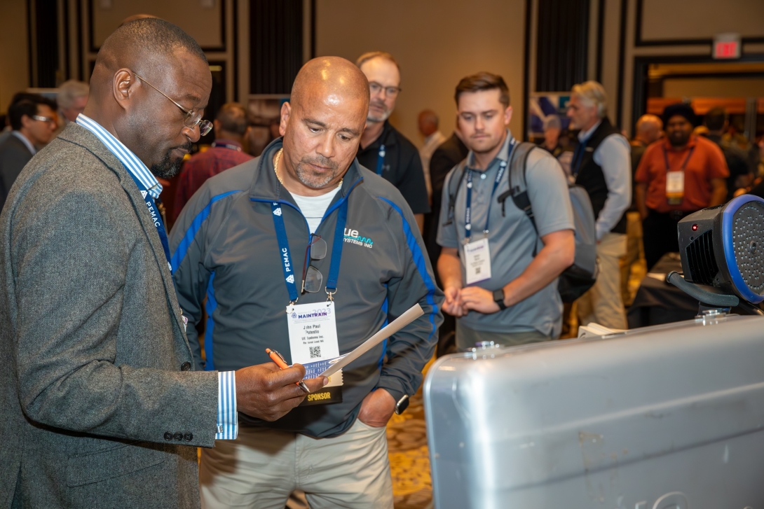 Delegates at MainTrain having a conversation on the exhibition floor