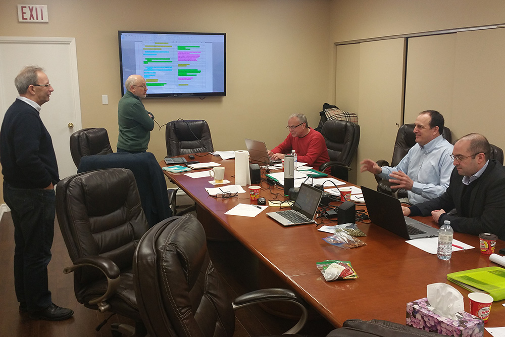 The Toronto-based board members around the board table in Mississauga, ON.